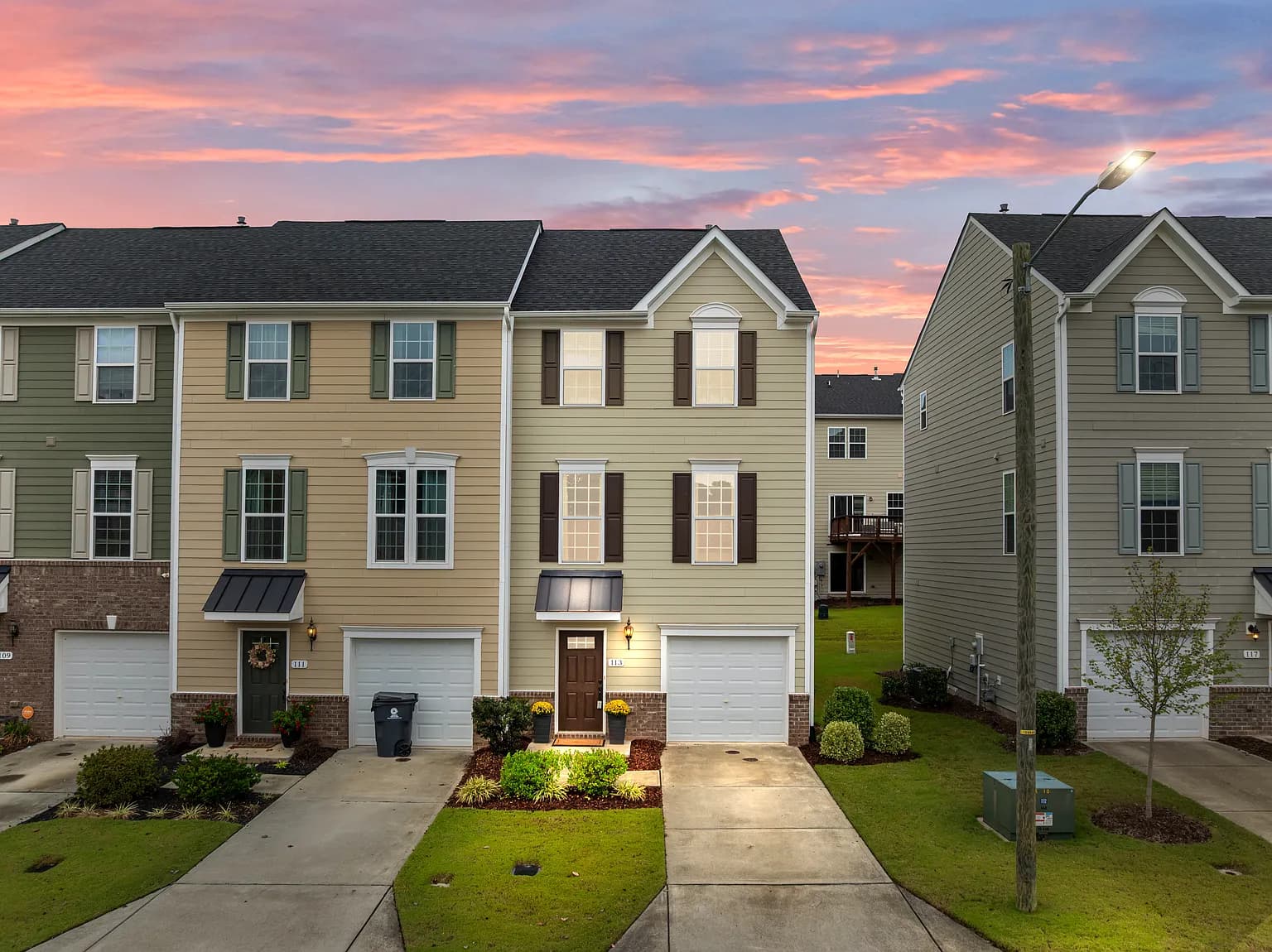 Stunning twilight exterior of modern townhome community